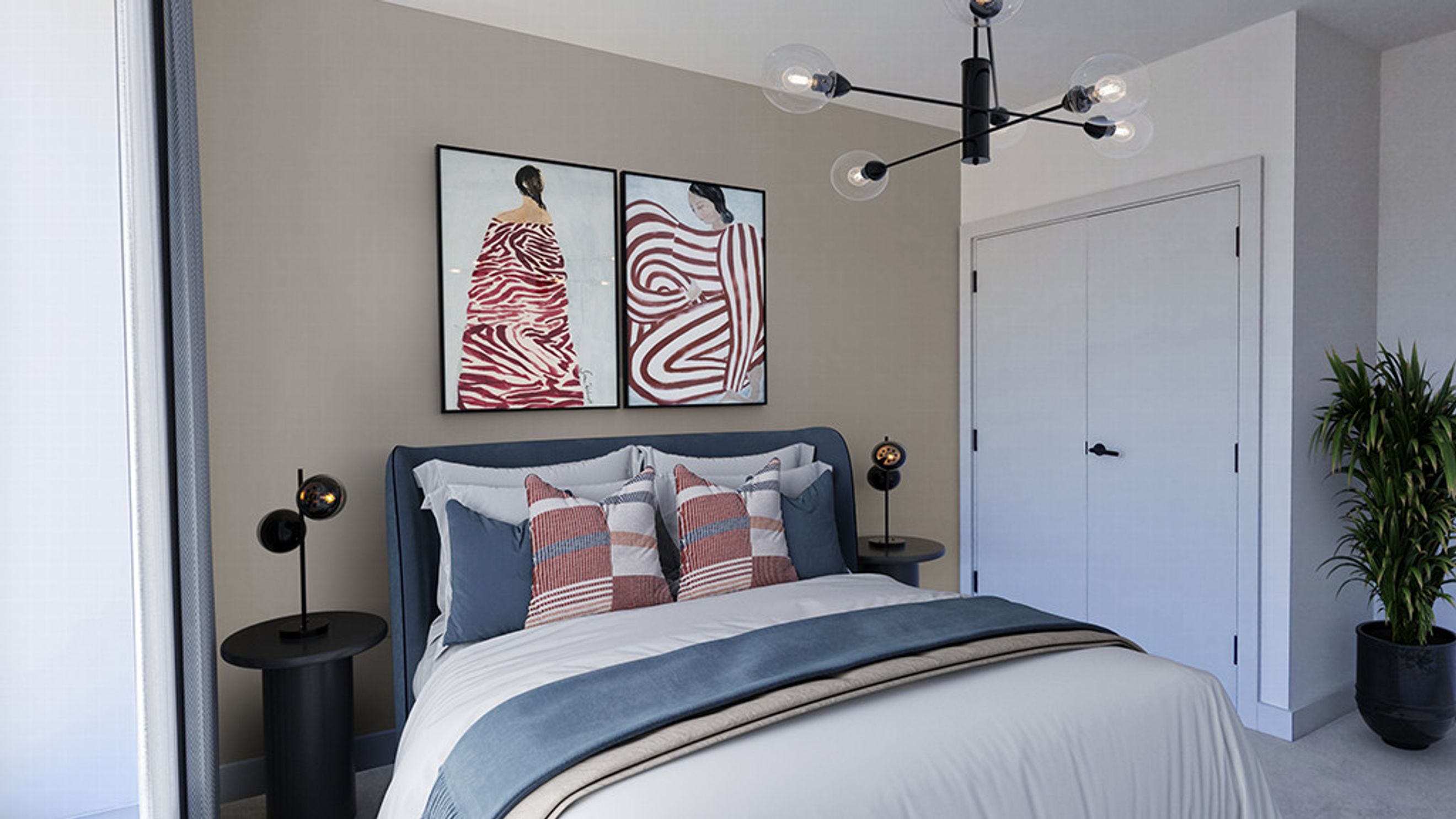 A bedroom with a bed, two paintings, a chandelier, and a closet.