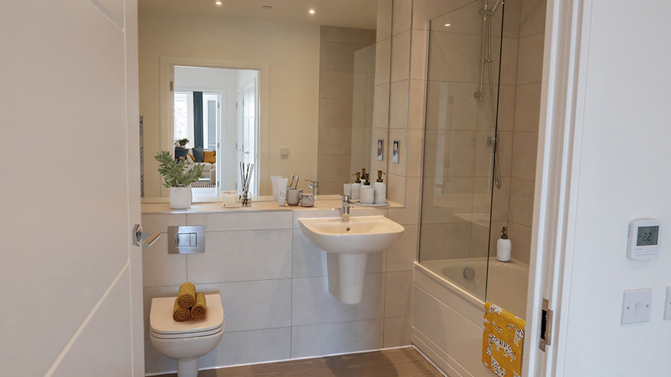 A bathroom with a toilet, sink, and bathtub with a shower.