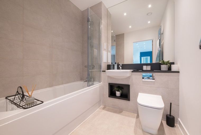 A bathroom with a bathtub, sink, and toilet.
