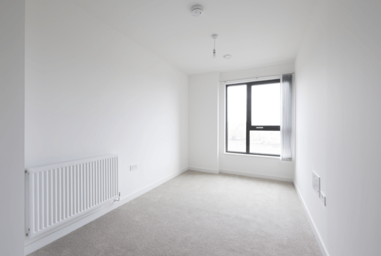 A room with a radiator and a large window.