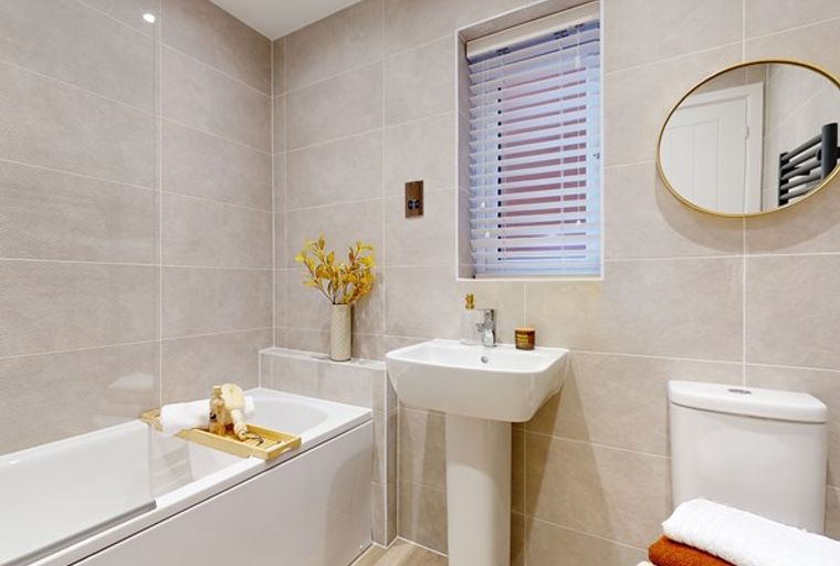 A bathroom with a bathtub, sink, and toilet.