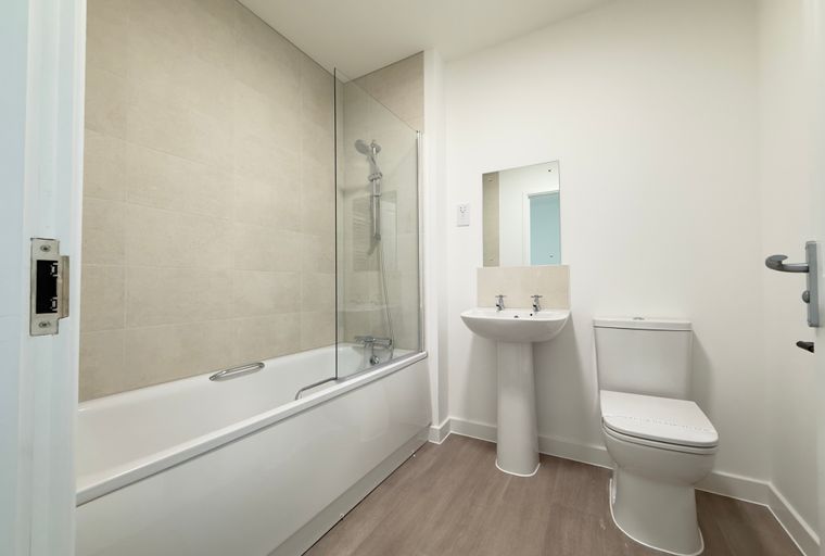 A bathroom with a bathtub, sink, and toilet.