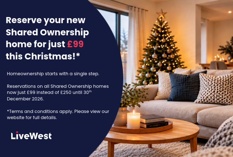 A living room decorated for Christmas with a sofa, coffee table, and a Christmas tree.
