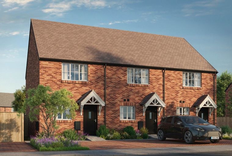 A row of brick houses with pitched roofs and front porches, a car parked in the driveway, and a garden with trees and flowers.