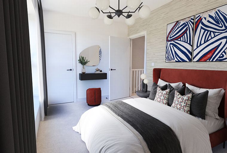 A bedroom with a bed, abstract art, and a vanity.