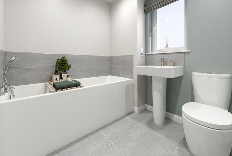 A bathroom with a bathtub, sink, and toilet.