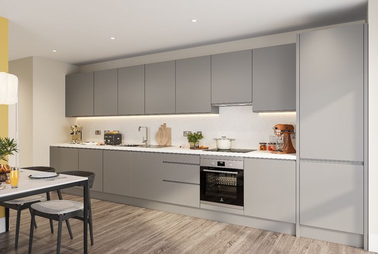 A modern kitchen with grey cabinets, white countertops, and integrated appliances.