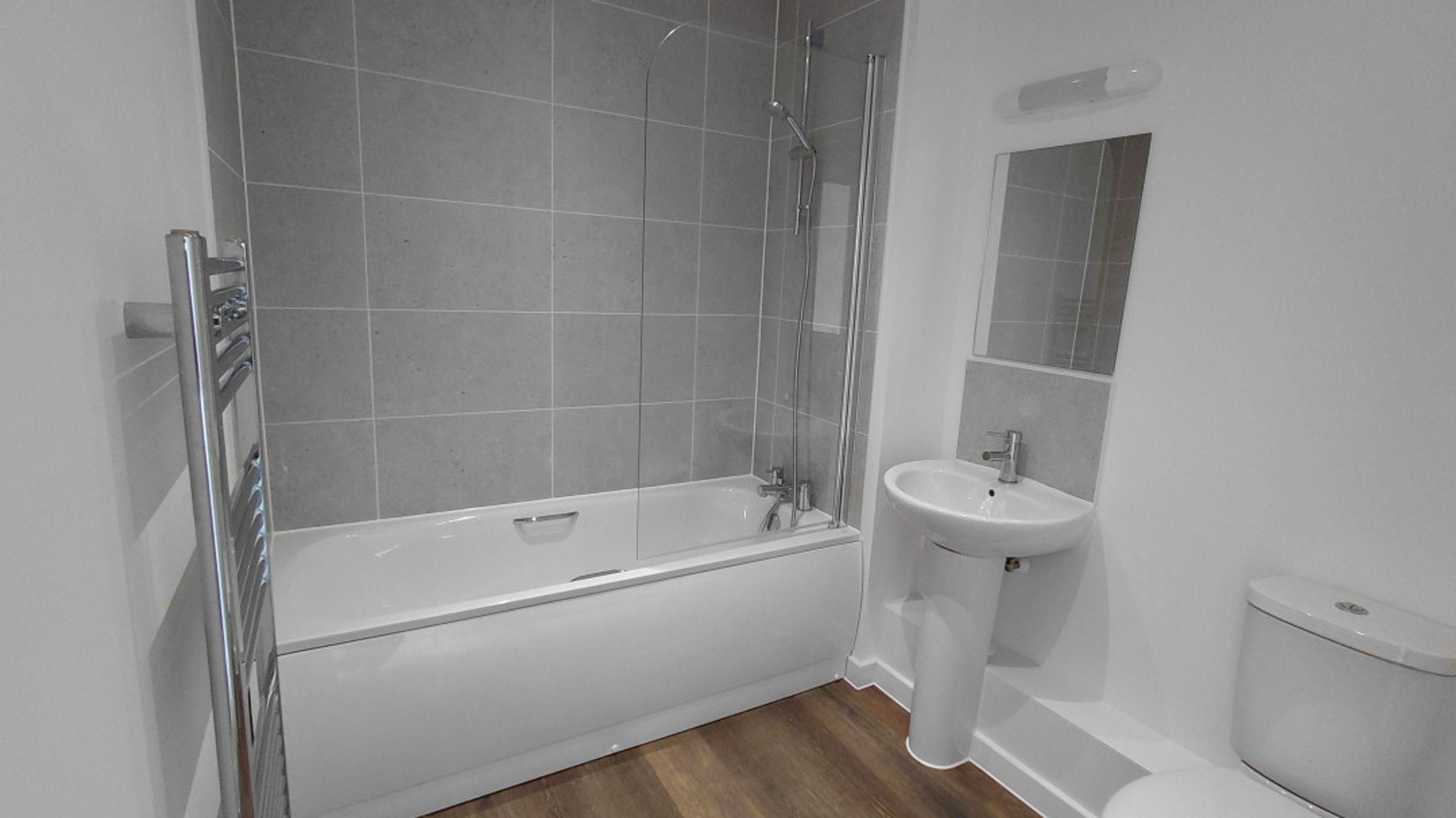 A bathroom with a bathtub, a sink, and a toilet.