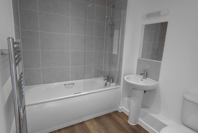 A bathroom with a bathtub, a sink, and a toilet.