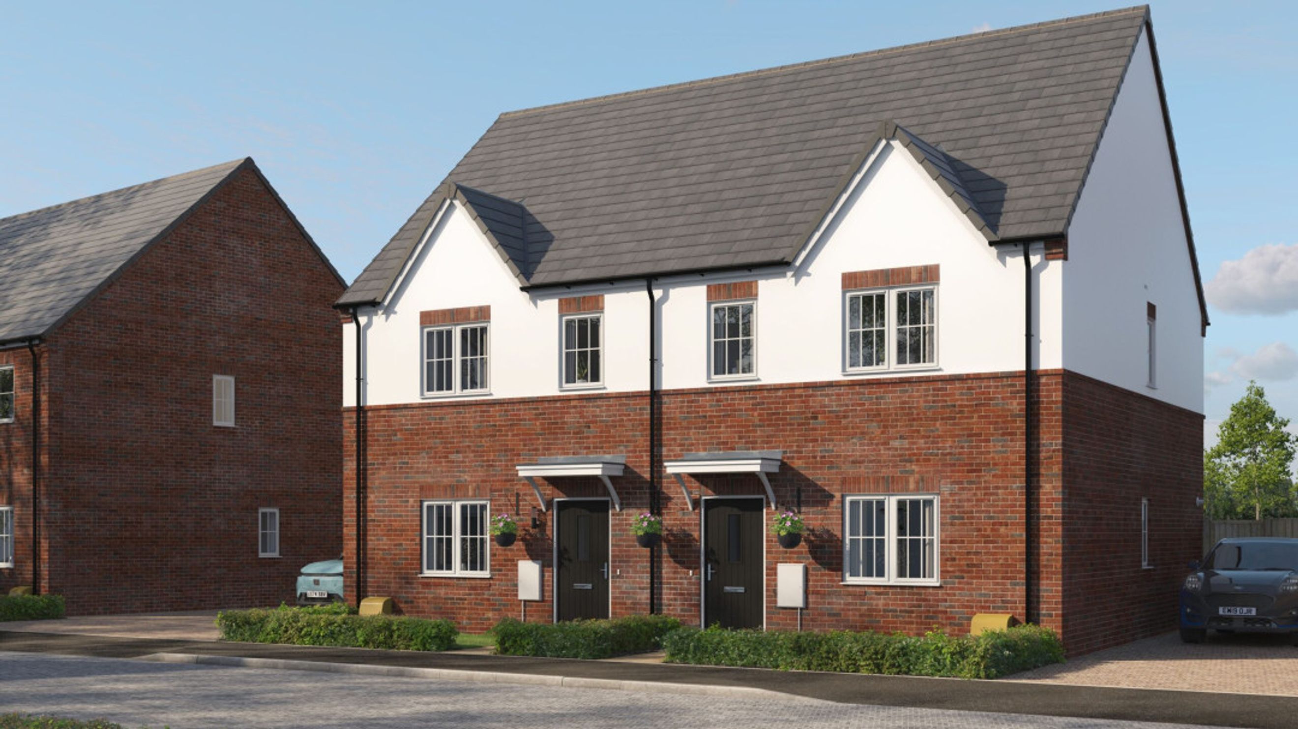 A pair of modern semi-detached houses with red brick lower walls and white upper walls, under grey tiled roofs.