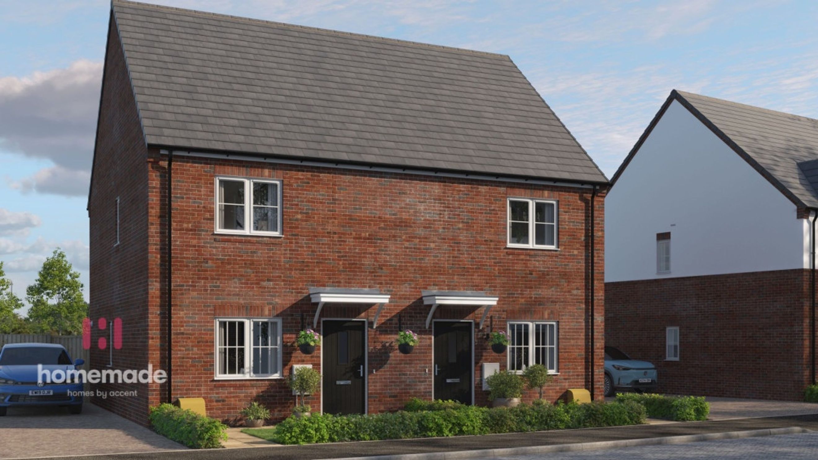 A pair of red brick semi-detached houses with grey tiled roofs under a cloudy sky.