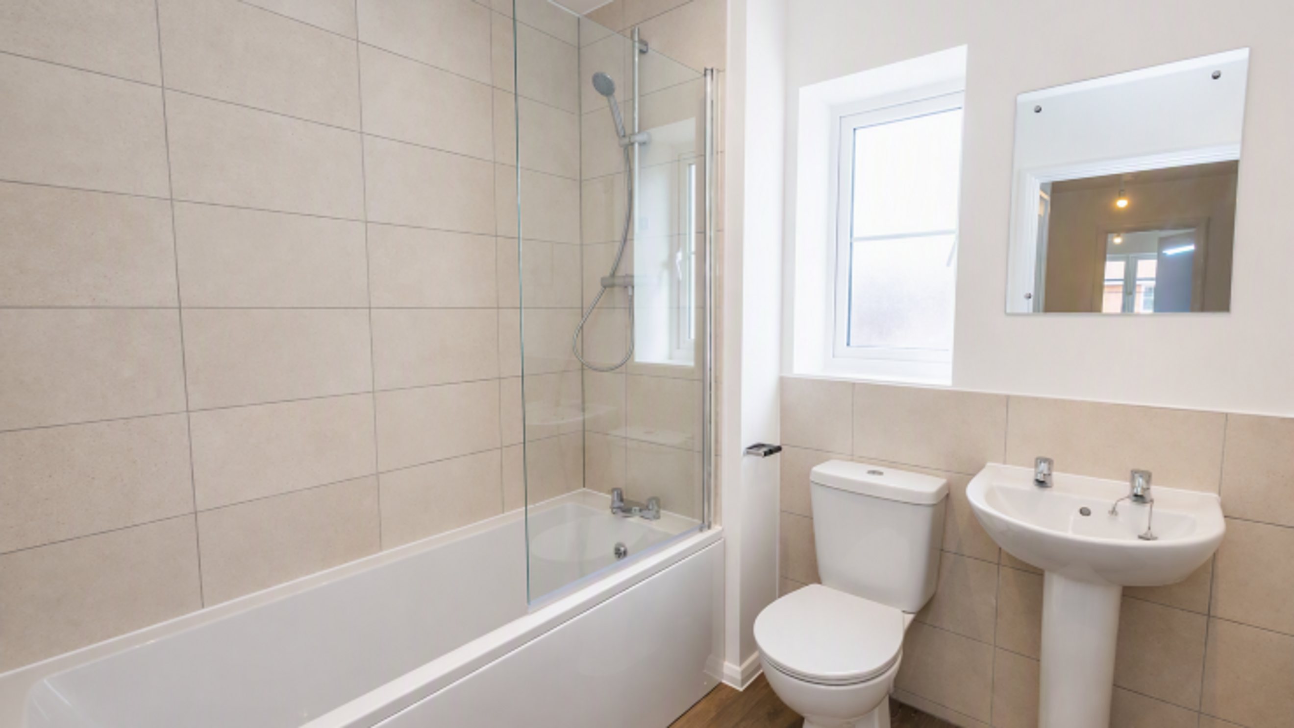 A bathroom with a bathtub, shower, toilet, and sink.