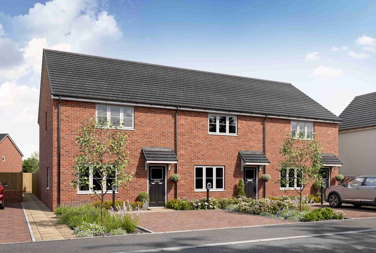 A row of red brick houses with grey tiled roofs and manicured front gardens.