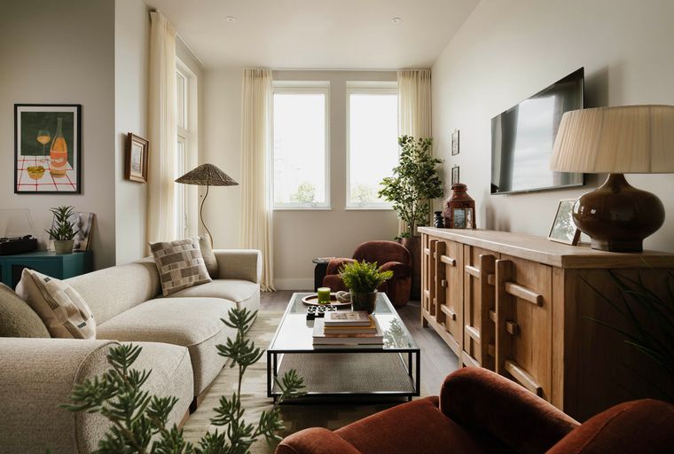 A living room with a sectional sofa, coffee table, and a credenza.