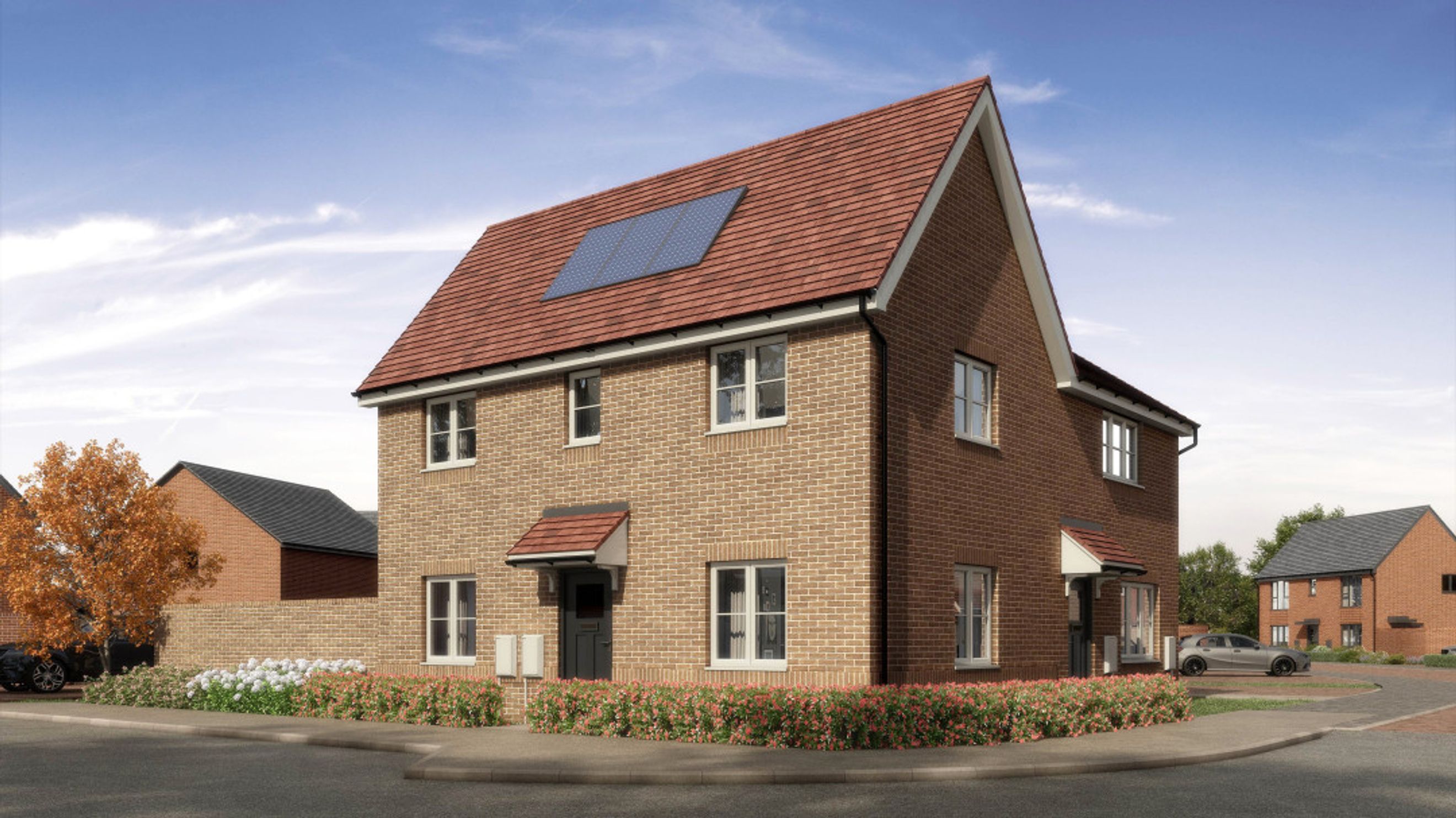 A brick house with a red tile roof and solar panels.