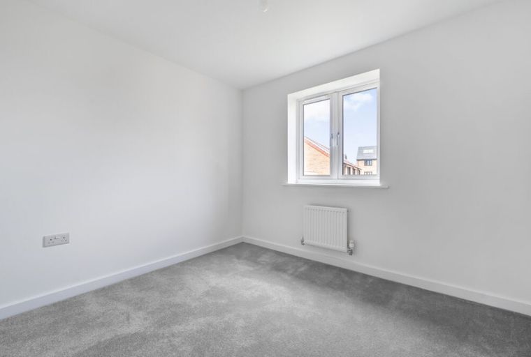 A room with a window and a radiator.