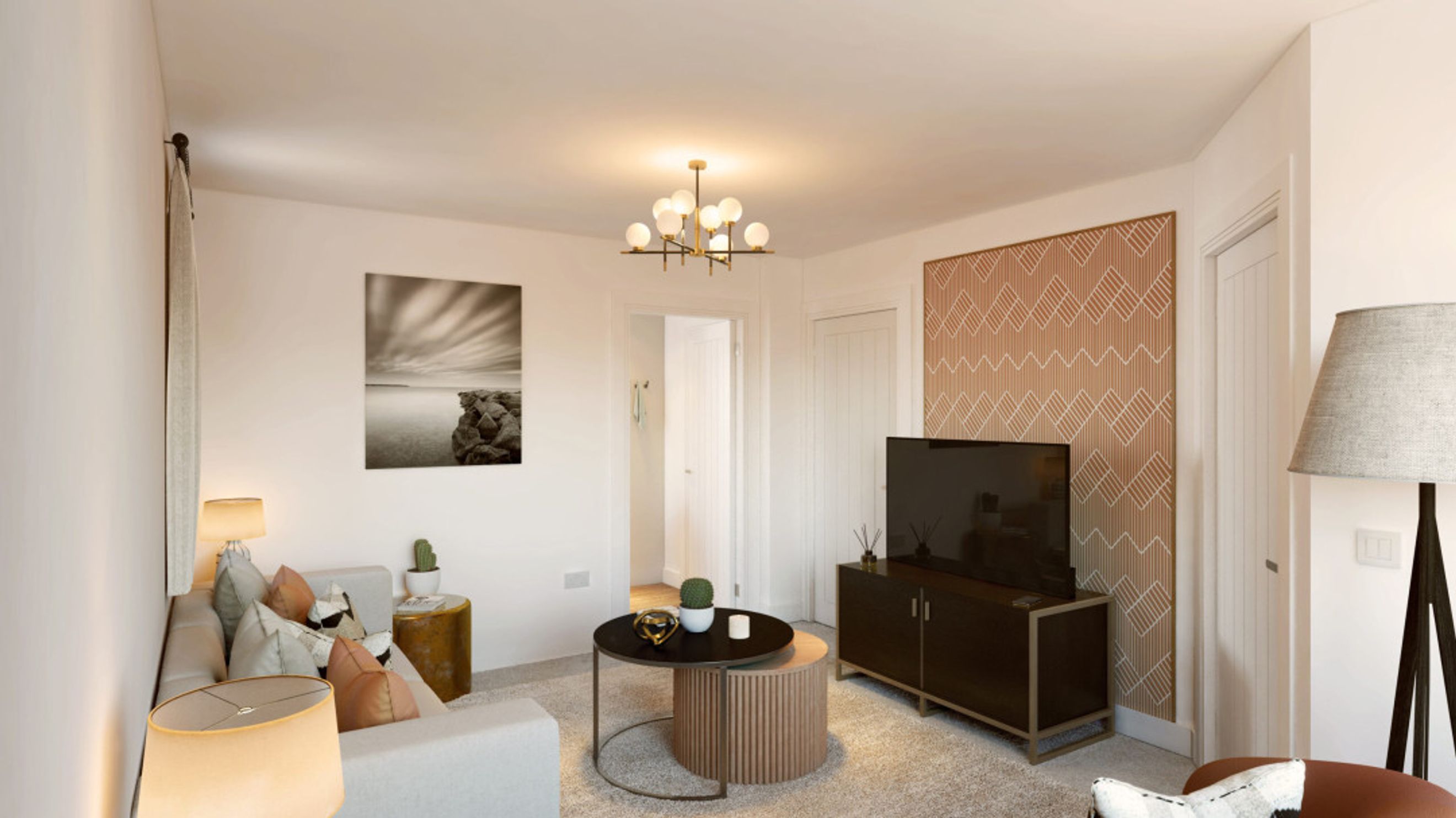 A living room with a sofa, coffee table, television, and a chandelier.