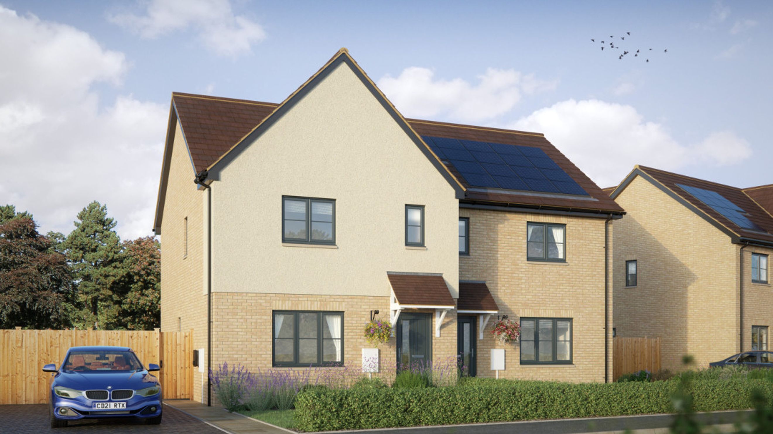 A modern semi-detached house with solar panels on the roof, a driveway, and a car.