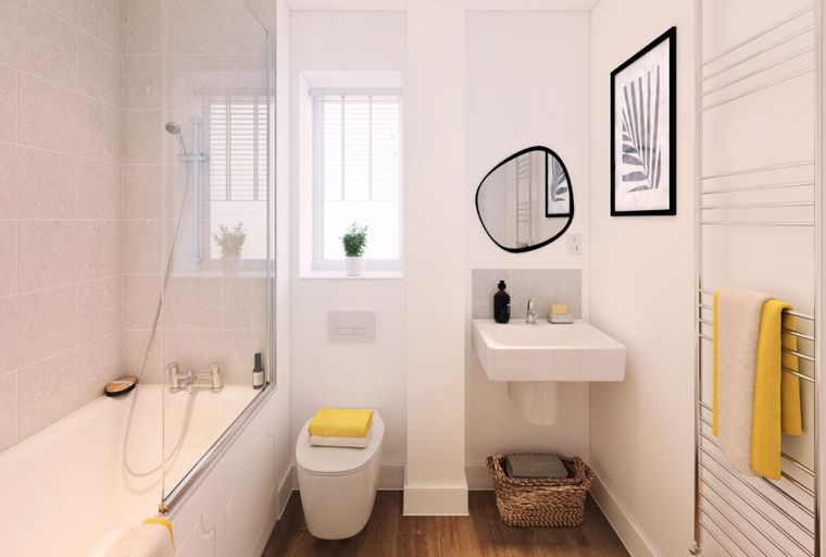 A bathroom with a bathtub, toilet, sink, and towel warmer.