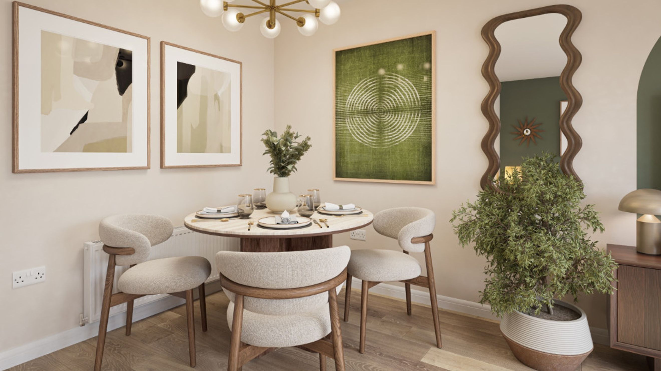 A dining area with a round table, chairs, and artwork on the wall.