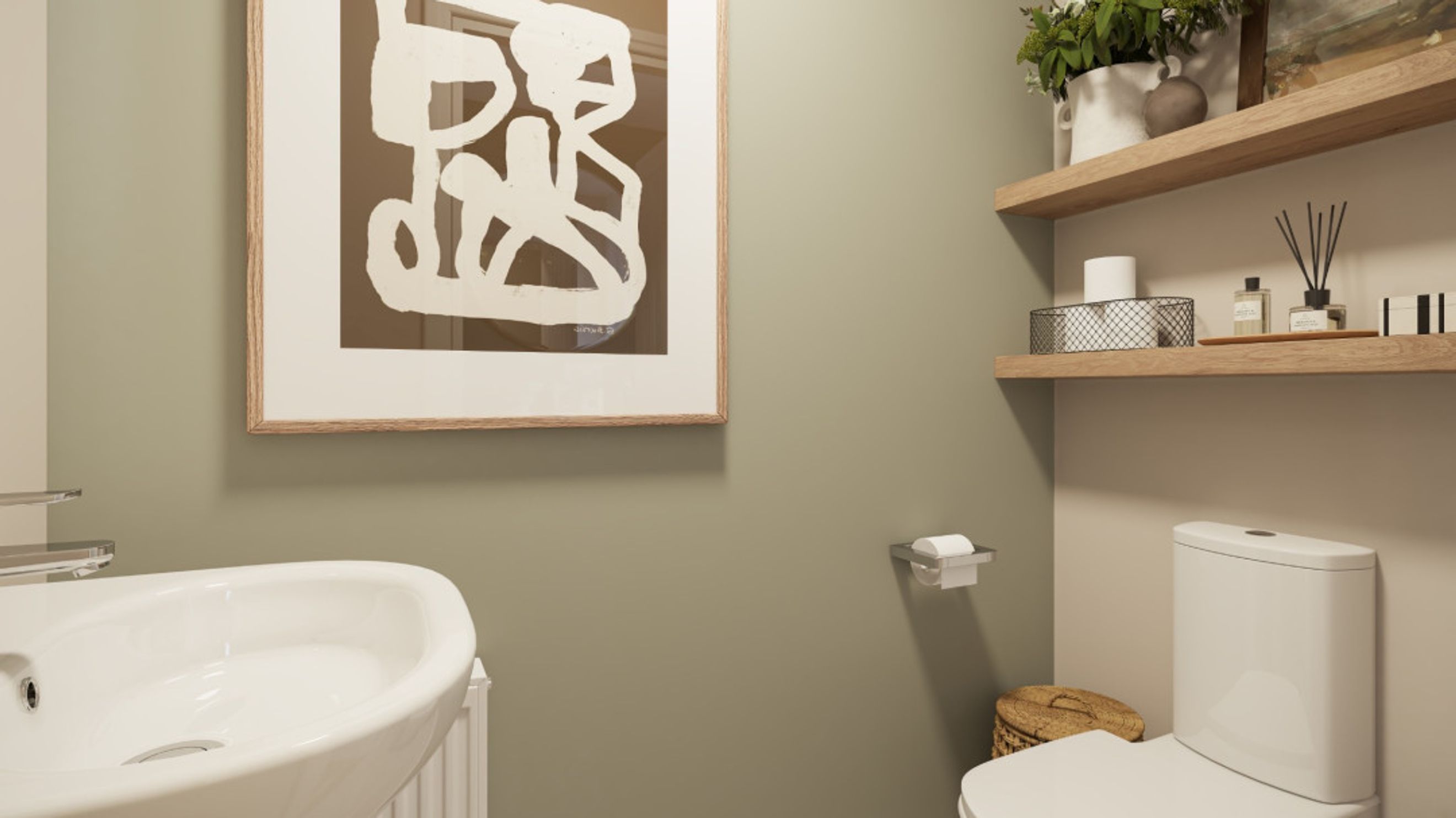 A bathroom with a sink, toilet, and framed artwork.