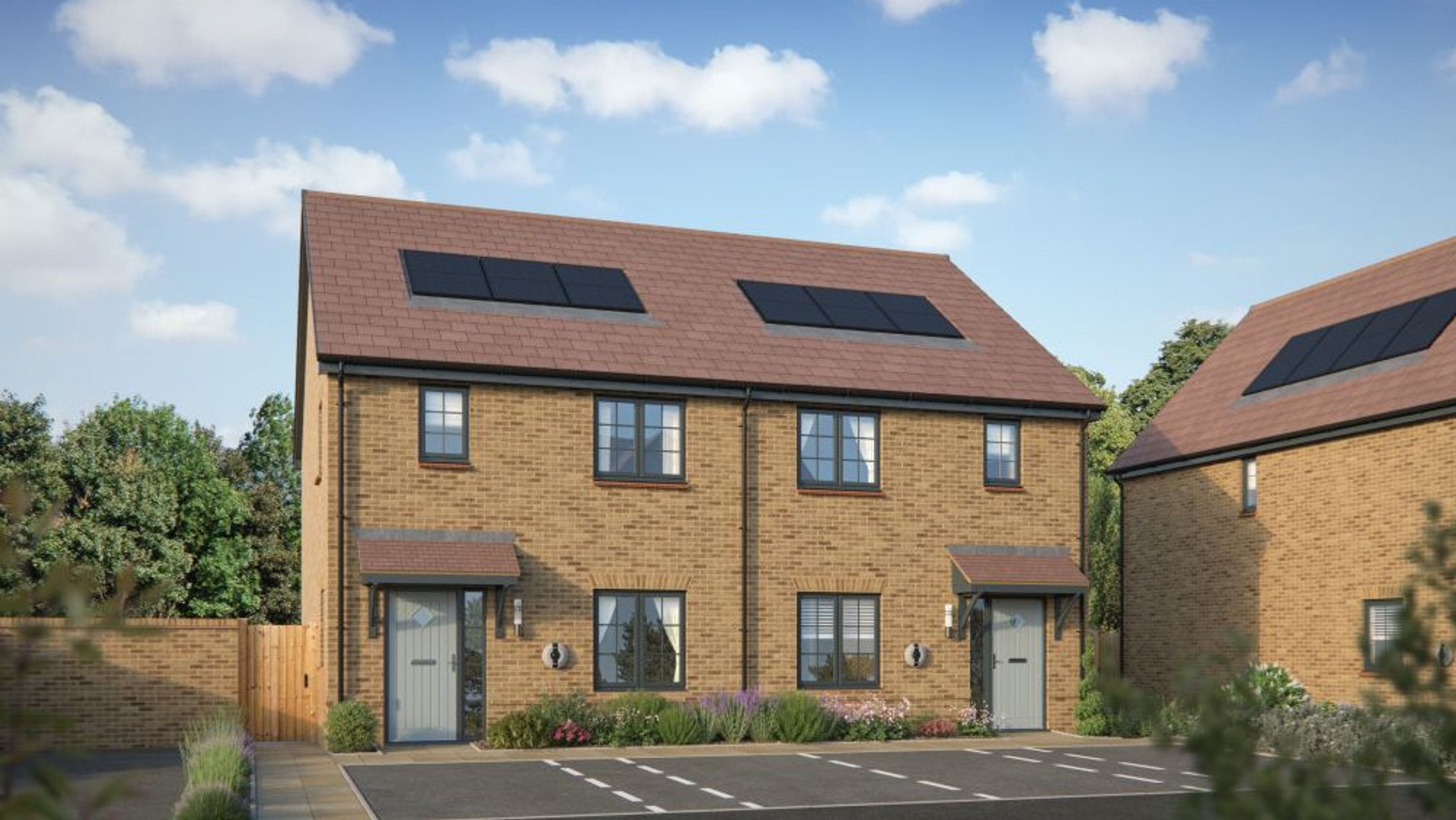 A pair of modern brick semi-detached houses with solar panels on the roof.