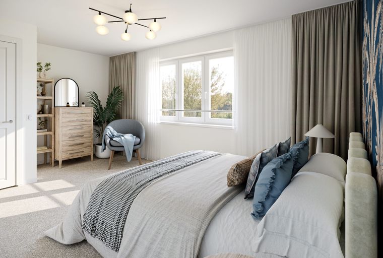 A bedroom with a bed, dresser, armchair, and window.