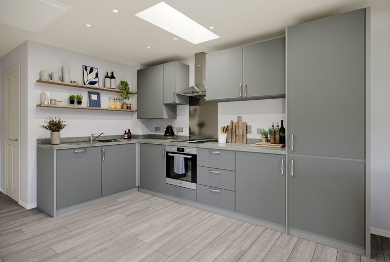 A modern kitchen with grey cabinets, a countertop, and an oven.