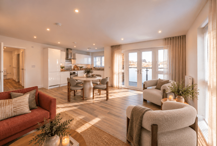 A living room and kitchen area with a dining table and chairs.