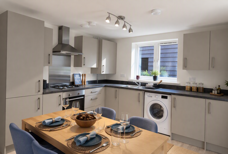 A kitchen and dining area with a table set for a meal.