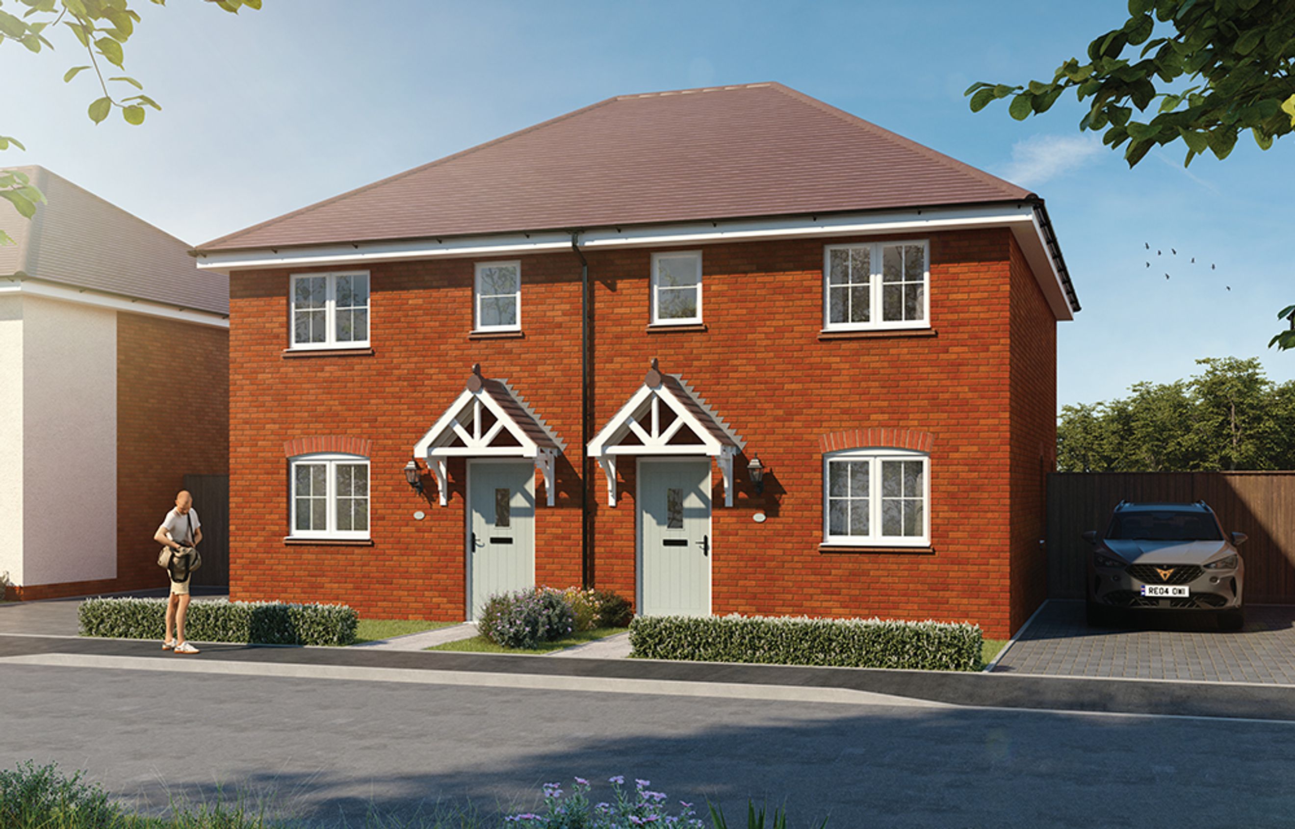 A pair of red brick semi-detached houses with white-framed windows and grey front doors, parked car in driveway.