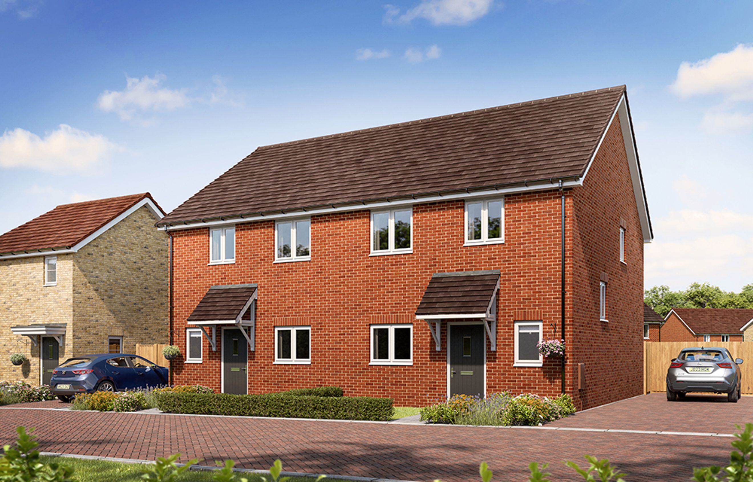 A row of modern brick houses with tiled roofs and driveways.