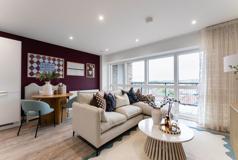 A living room and dining area with a sofa, coffee table, dining table, and chairs.